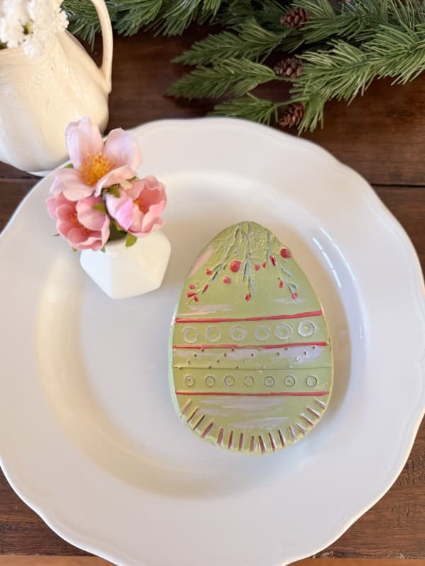 Easter Egg Plates made from air-dry clay decorate an Easter Table with Pottery Barn Easter Decorations Copy Cats. 