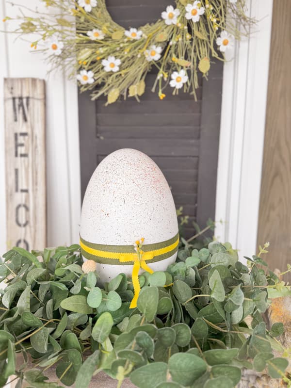 Dollar Tree Large Speckled DIY Easter Egg in Planter with greenery.  DIY Easter Decorations for outside or inside.  