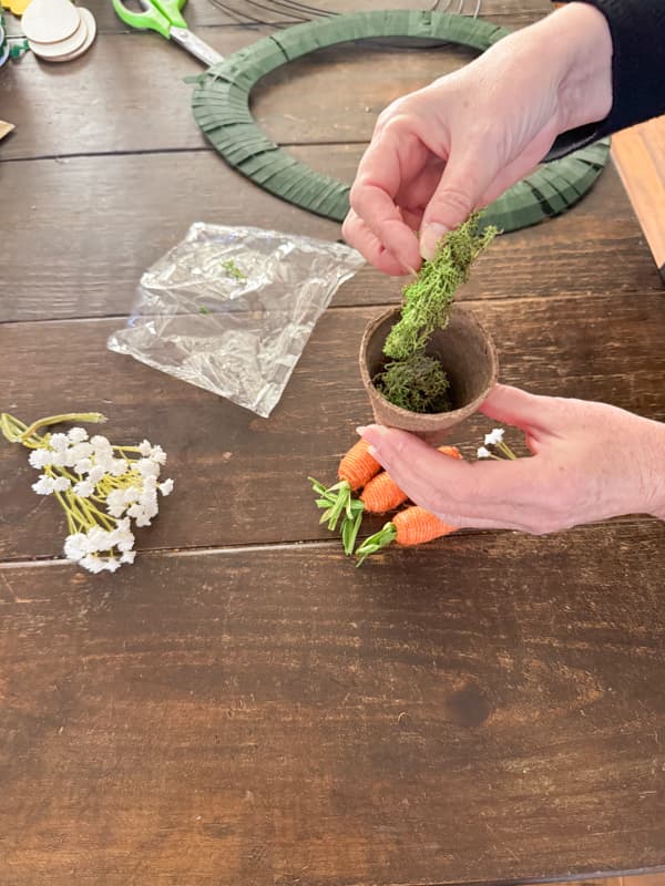 Fill Seed pots with reindeer moss to attach to DIY Easter Wreath