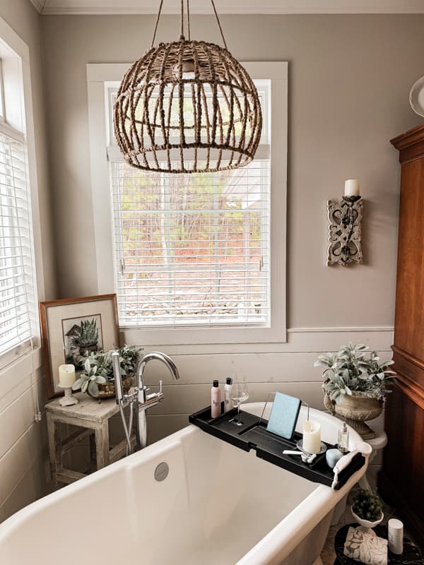 Basket Light over free standing tub with Vintage stools and bathroom decor ideas.  