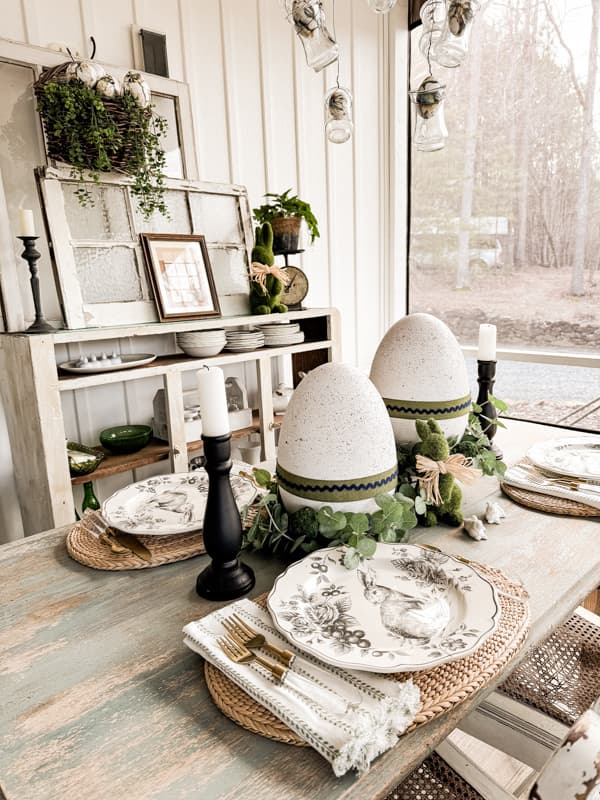 Farmhouse Porch dining table with DIY Speckled Large Easter Eggs: Dollar Tree Craft with black and white bunny dishes.