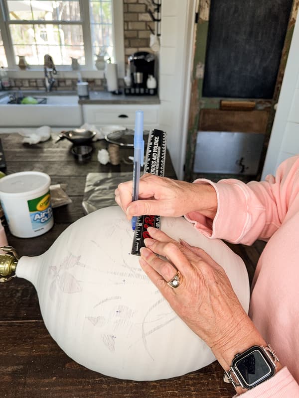 Measure and mark the position of the faux hobnail wood ball for placement.  