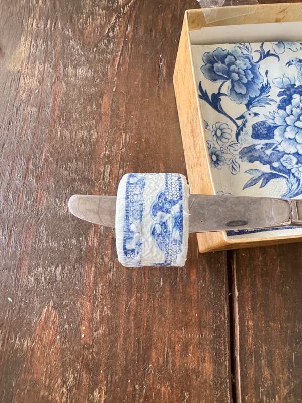 Add blue and white napkin decoupage to thrift store napkin rings for cheap tableware ideas.  
