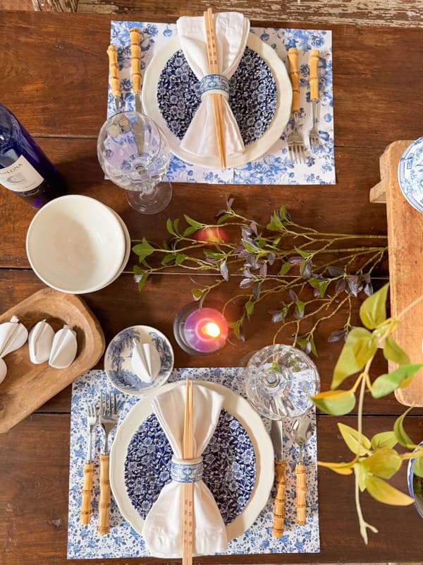 Chinoiserie Table Setting with Blue and White paper placemats.  Bamboo cutlery and chop sticks.  