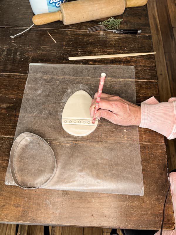 Press Straws into clay to make decorative designs