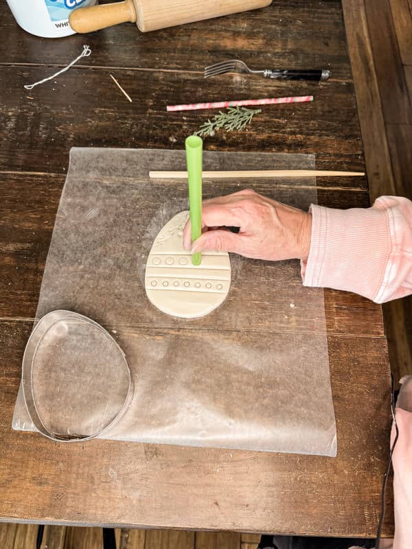 Press Straws into clay to make decorative designs. 