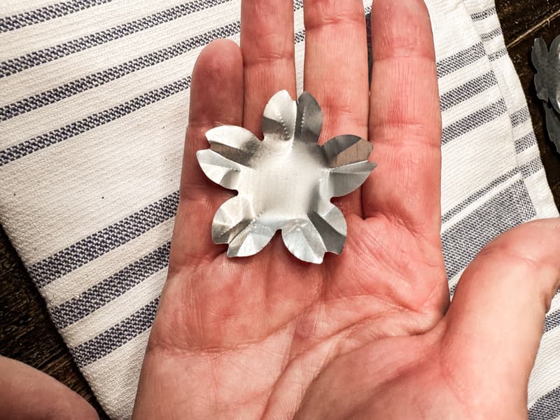 Press aluminum flowers to create design for DIY wreath