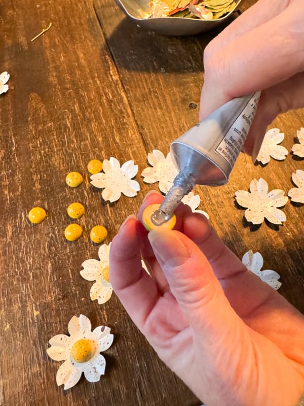 Add wood centers to upcycled flowers.