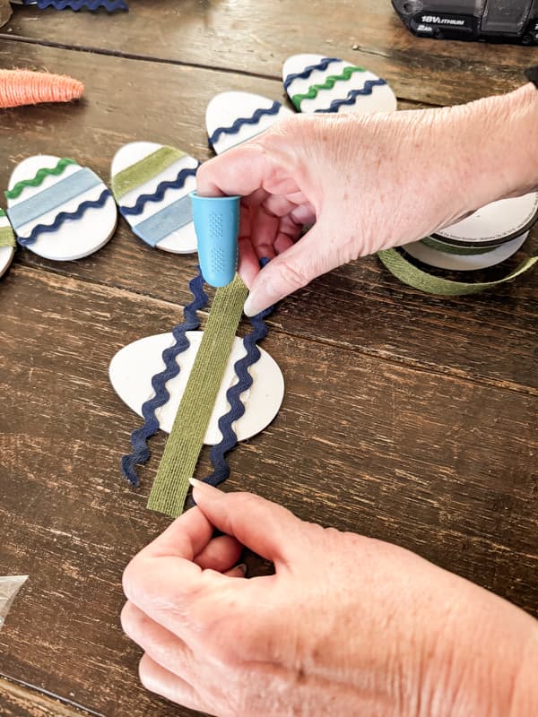 Decorate the wooden Easter Eggs with ribbon to make a DIY Easter Wreath