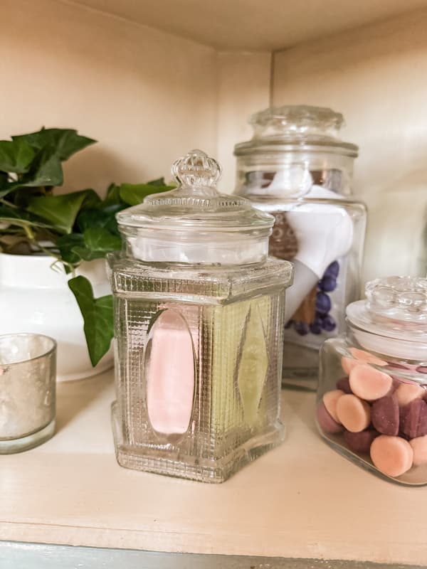 Apothecary Jars hold soap and vintage bathroom accessories.  