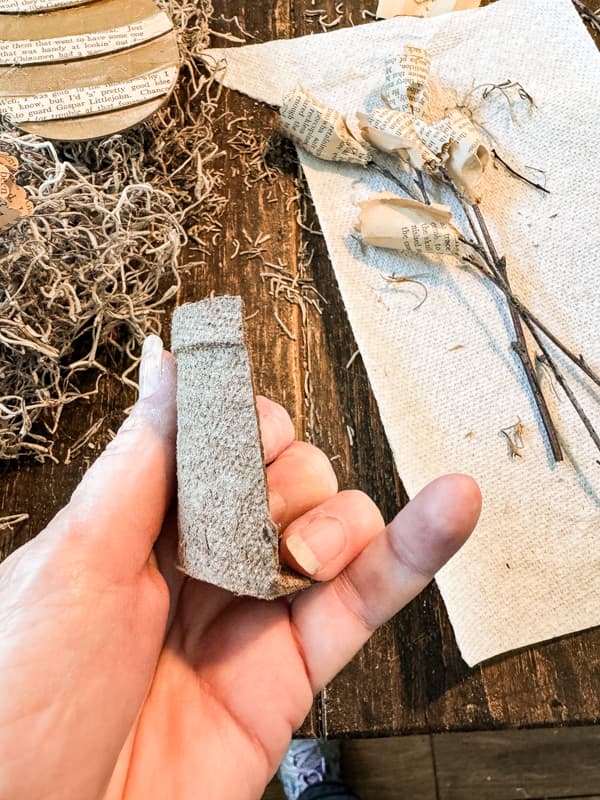 Cut seed pot in half for old book page flowers.