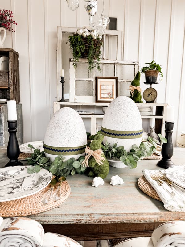 Rustic FarmhousePorch dining table with DIY Speckled Large Easter Eggs: Dollar Tree Craft with black and white bunny dishes.