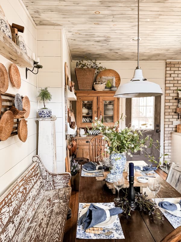 Hutch with European Harvest Basket and thrift store plate baskets are displayed on the wall.  