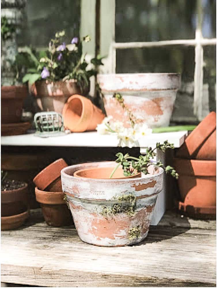 DIY Aged Clay Pots for a vintage potting bench outdoor decor.