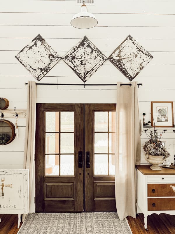 Architectural Salvaged ceiling tins displayed over farmhouse door.