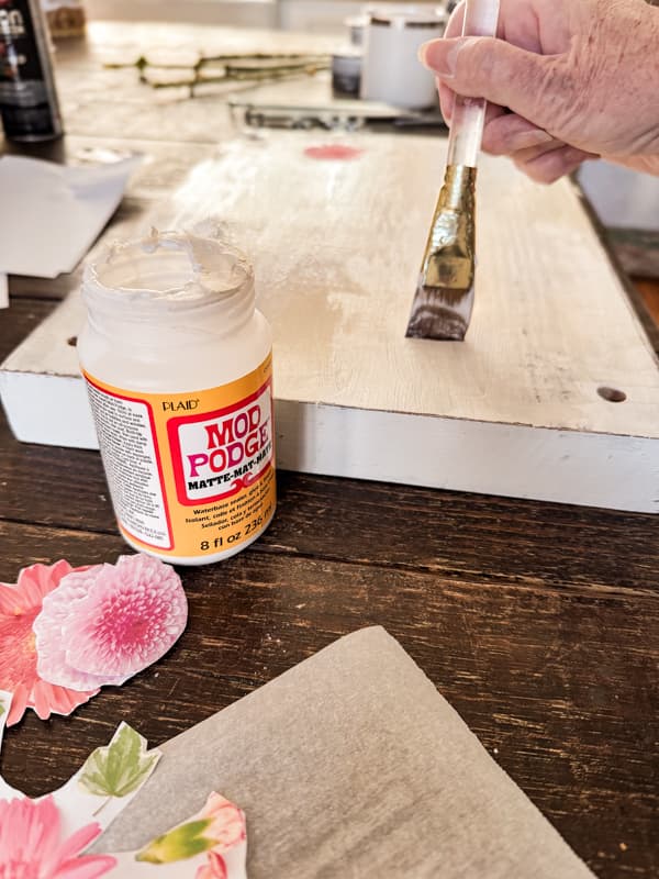 add mod podge to top of upcycled wood top for pressing flowers.