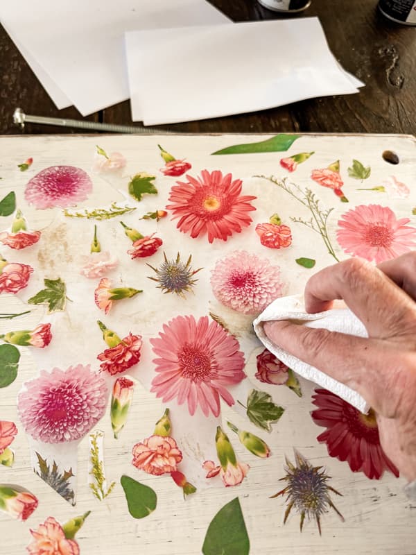 add  wax to decoupaged floral print on top of upcycled wood.  