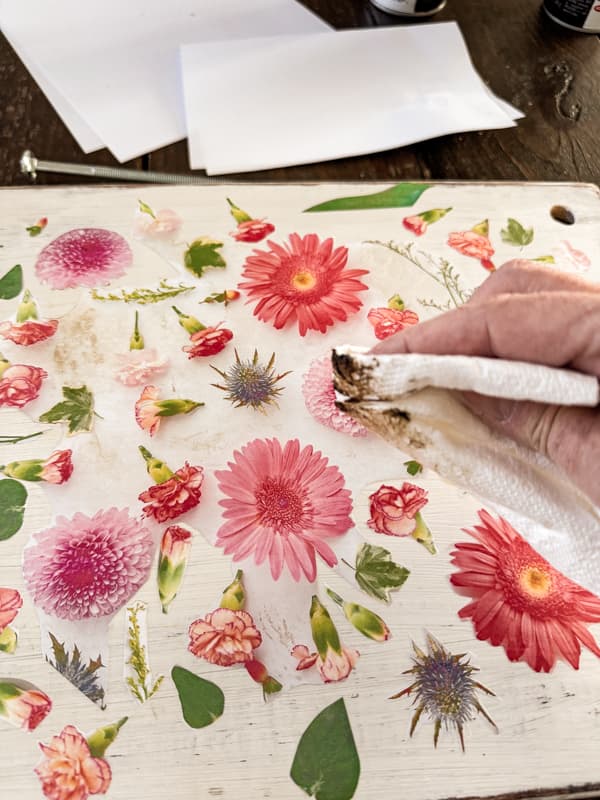 add dark wax to decoupaged floral print on top of upcycled wood.  