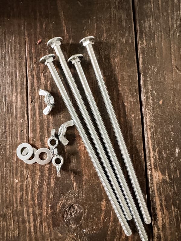 Carriage bolts, washer and wing nuts to construct a DIY Flower Press