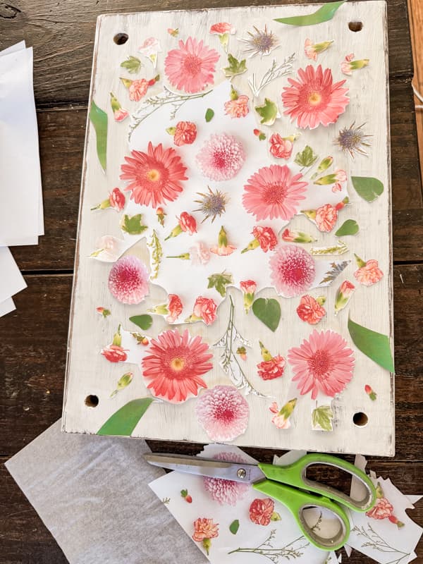 lay cut out of flower print on the top of scrap wood top to heat decoupage.  