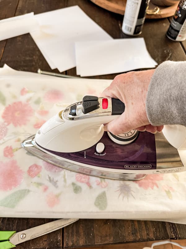 heat press the floral print to the scrap wood top with iron.  