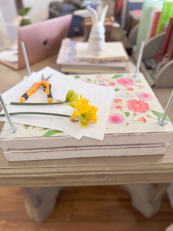 DIY flower press with daffodills and decoupage floral print top. 