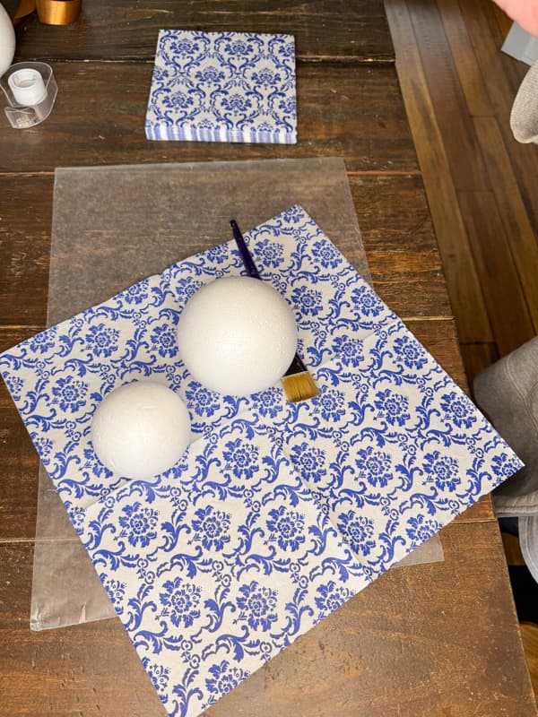 Cover styrofoam balls with napkin decoupage for stylish home decor.