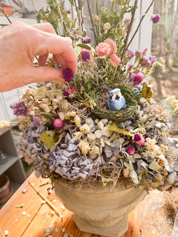 Add small dried flowers to the dried hydrangea arrangement.  Country Chic Spring Centerpiece for rustic charm. 