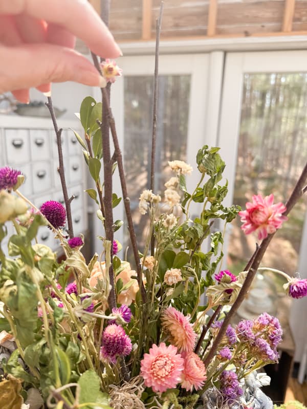 Twigs and dried flowers create a stunning centerpiece for Spring Farmhouse decorating.  