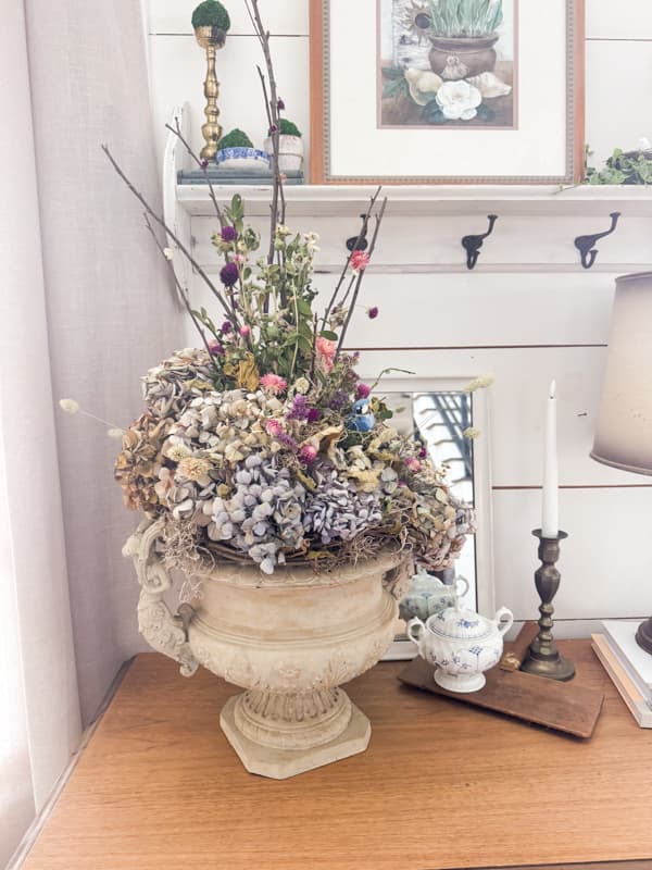 Farmhouse rustic table arrangement for spring with foraged twigs, grapevine and dried hydrangeas.  