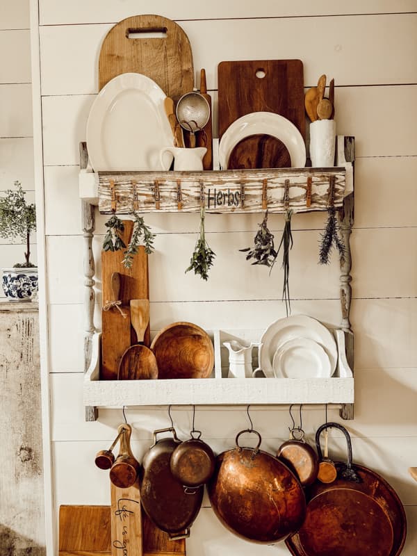 rustic drying rack  on DIY wall plate rack in farmhouse kitchen with ironstone, vintage copper and breadboards.