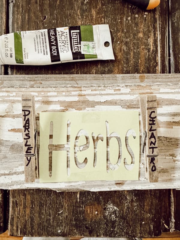 Stencil the word HERBS to the center of the DIY herb drying rack.  