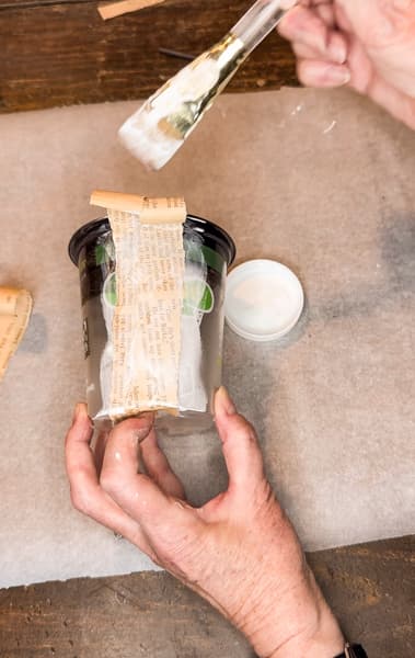 Add old book pages to upcycle plastic flower pots and cover with mod podge for new flower pots. 