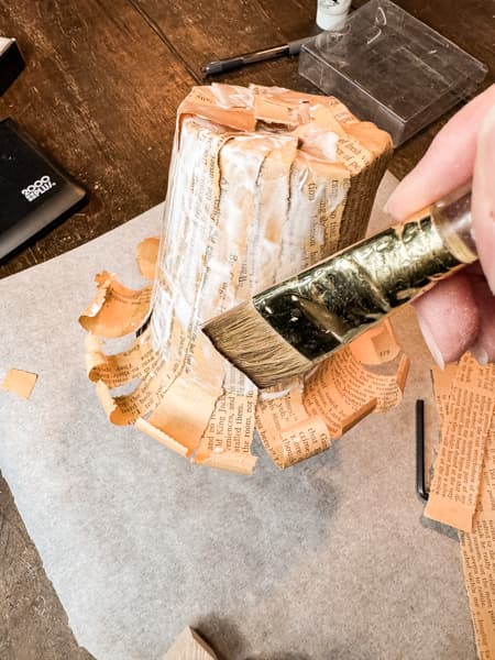 Add old book pages to upcycle plastic flower pots and cover with mod podge for new flower pots. 