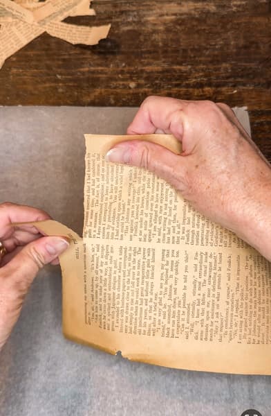 Tear old book pages for decoupage craft