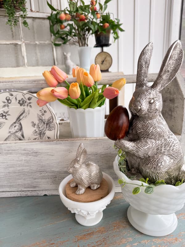 Rustic Farmhouse Easter Table with Tool box and milk glass centerpiece.  Pewter Bunnies in white milk glass bowls. 