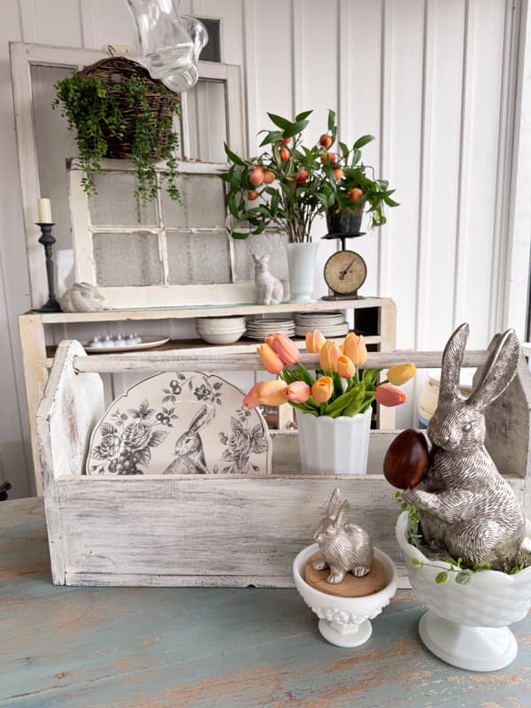 Rustic Farmhouse Easter Table with Tool box and milk glass centerpiece.  Pewter Bunnies in white milk glass bowls. 
