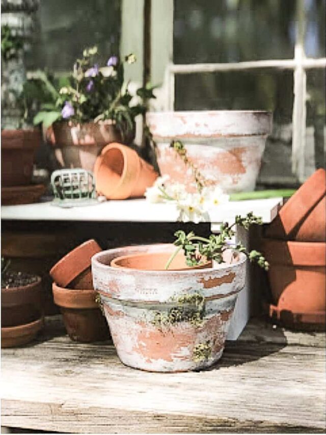 Aged DIY Vintage Terra Cotta Clay Pots on potting bench.