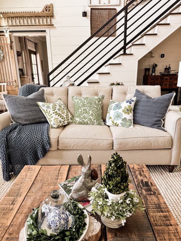 Living room sofa with new blue and white pillows.  