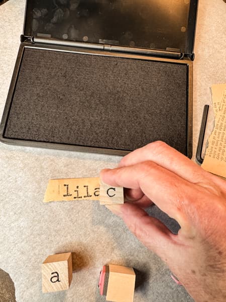 Make tags with letter stamps on old book page paper 