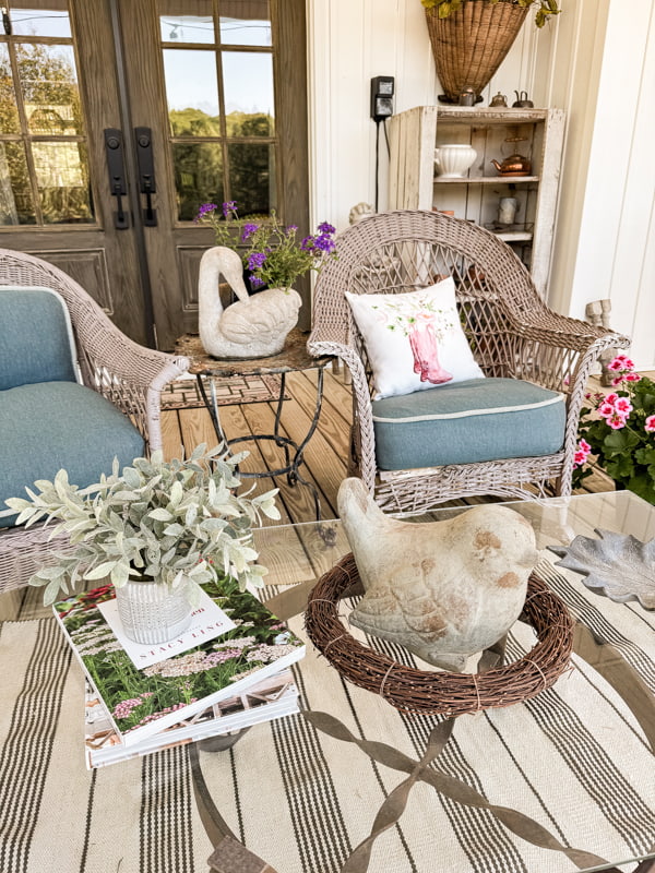 Bird statuary on coffee table and concrete garden statues swan with flowers.  