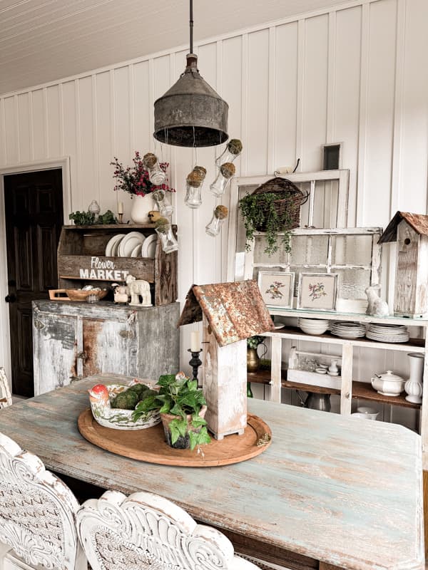 Spring Centerpiece with Birdhouse and birdbath on a wooden tray to decorate the screen porch farmhouse table.  
