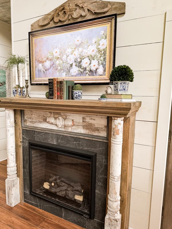 Blue and White Spring Mantel with old books and vintage brass candlestick holders. 