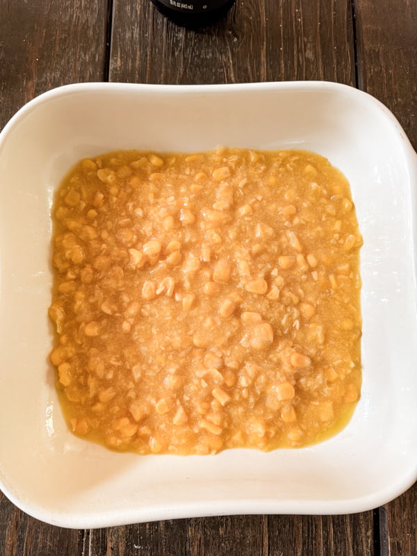 Cover bottom of baking dish with creamed corn.  