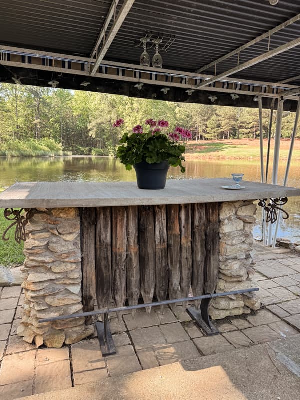 Outdoor Kitchen Bar with DIY Concrete Countertops.  DIY Bar built with field rock and old pier pilings.  