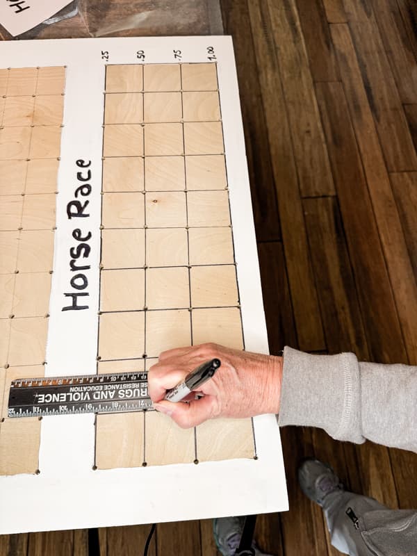 Highlight the grid lines with a black sharpie marker for the horse race game. 