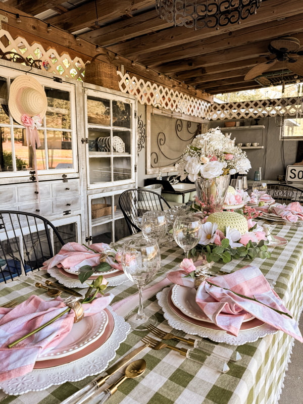 Pink and white mixed with green buffalo print table setting with festive hats for derby party ideas.  