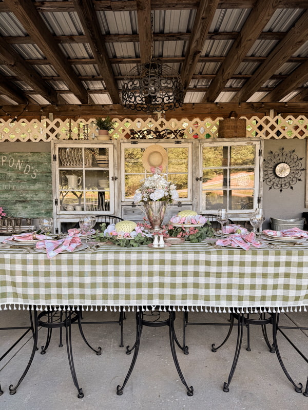 Kentucky Derby Party ideas for a creative tablescape with green buffalo print tablecloth on outdoor kitchen table. 