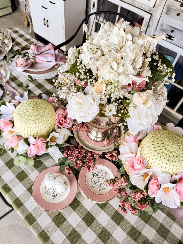 Kentucky Derby Tablescape centerpiece with festive hats and trophy floral centerpiece.  Vintage dessert dishes