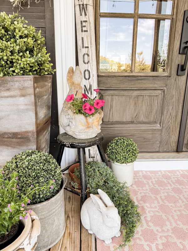 Bunny Planter on vintage stool beside front door.  